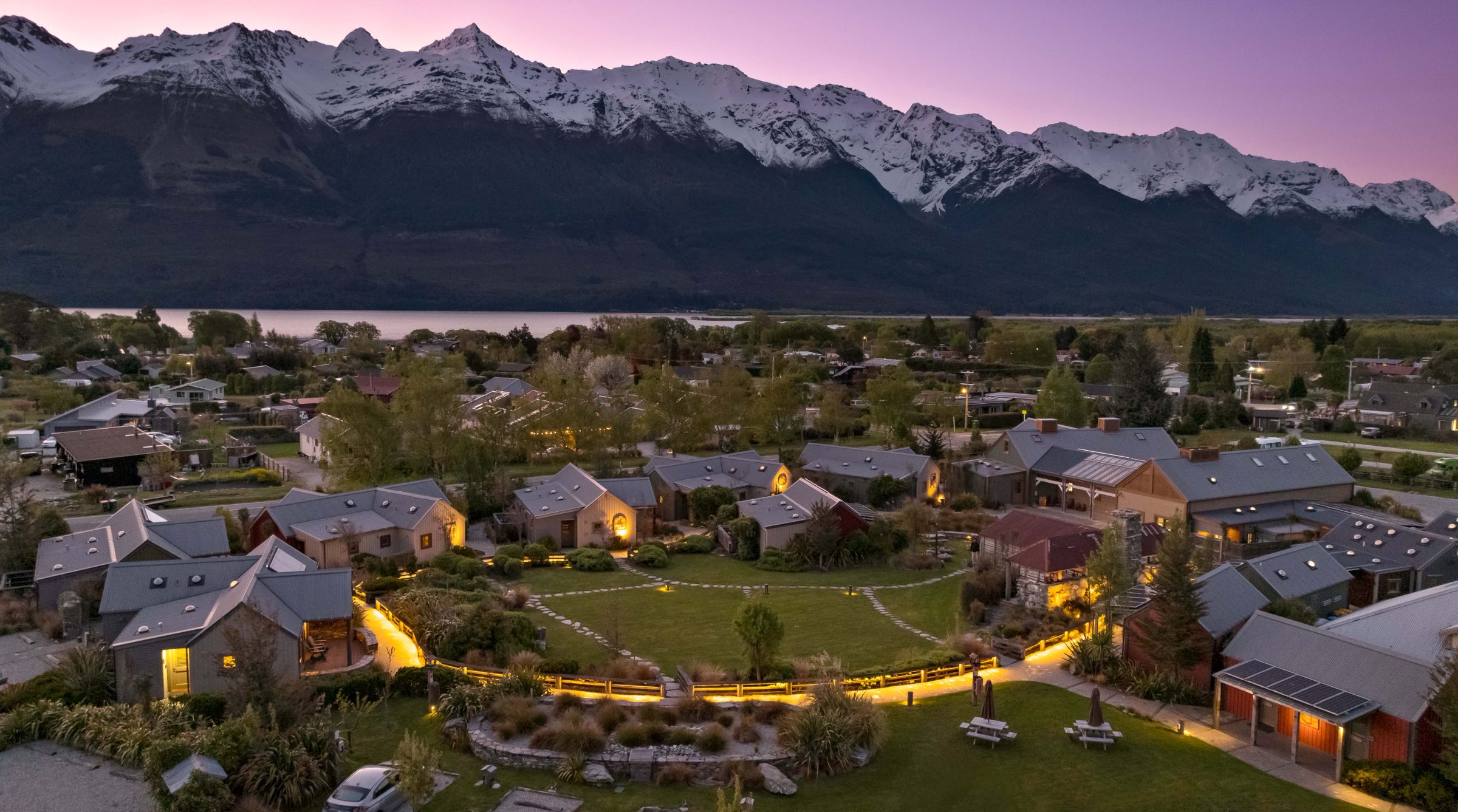The Headwaters Eco Lodge at dusk, Glenorchy, beneath the snow-covered Southern Alps