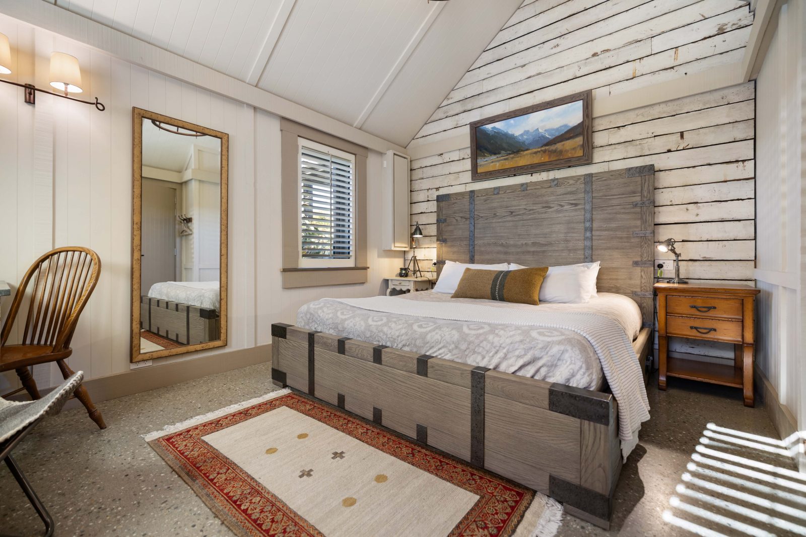 Inside a chalet at The Headwaters Eco Lodge, with reclaimed timber walls and a view to the garden